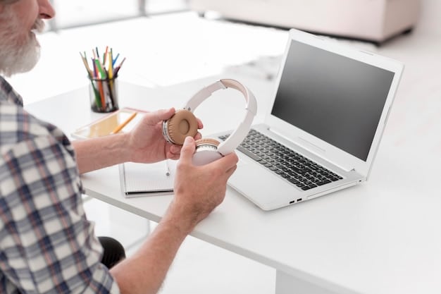 A close-up of a tutor's hands typing on a laptop keyboard, with a headset on and a whiteboard software interface visible on the screen. Focus on the tools of the trade.