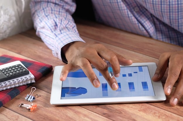 A person's hands holding a tablet and pointing at data analytics graphs, surrounded by product samples on a table, symbolizing strategic product research for e-commerce.