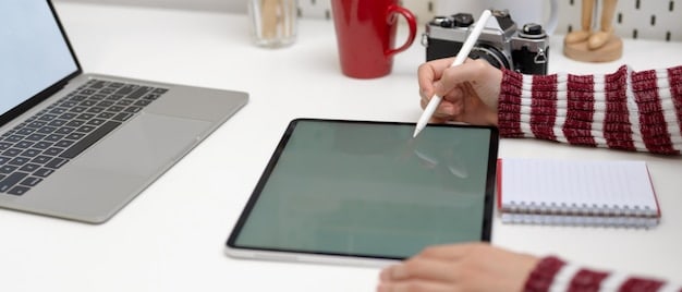 A close-up of a hand pointing at a laptop screen showing various digital product icons and a list of ideas, symbolizing brainstorming and product selection.