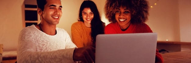 A group of diverse people looking at a laptop screen together, smiling and engaged, with charts and graphs subtly visible on the screen, illustrating collaborative planning and successful implementation of a business strategy.
